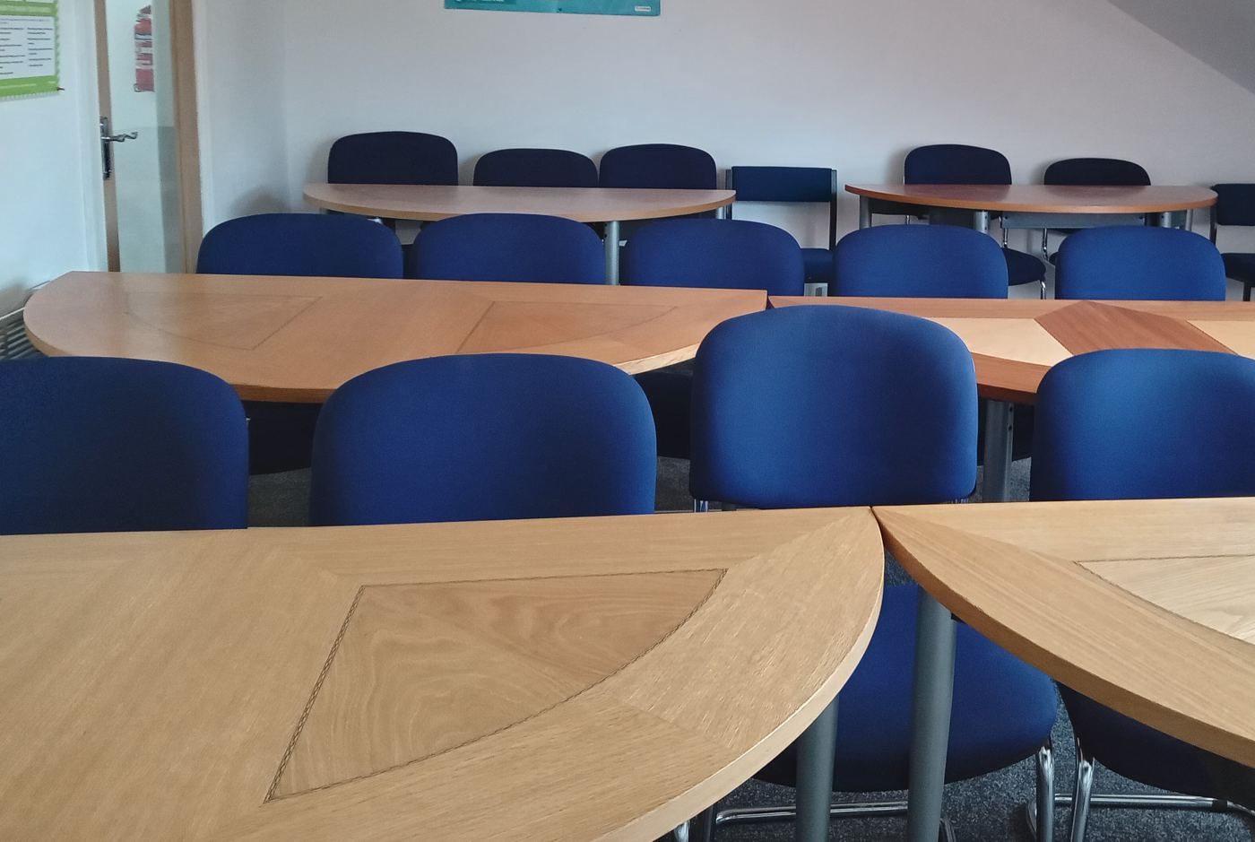 Bright training room in Liverpool with tables and chairs arranged classroom-style